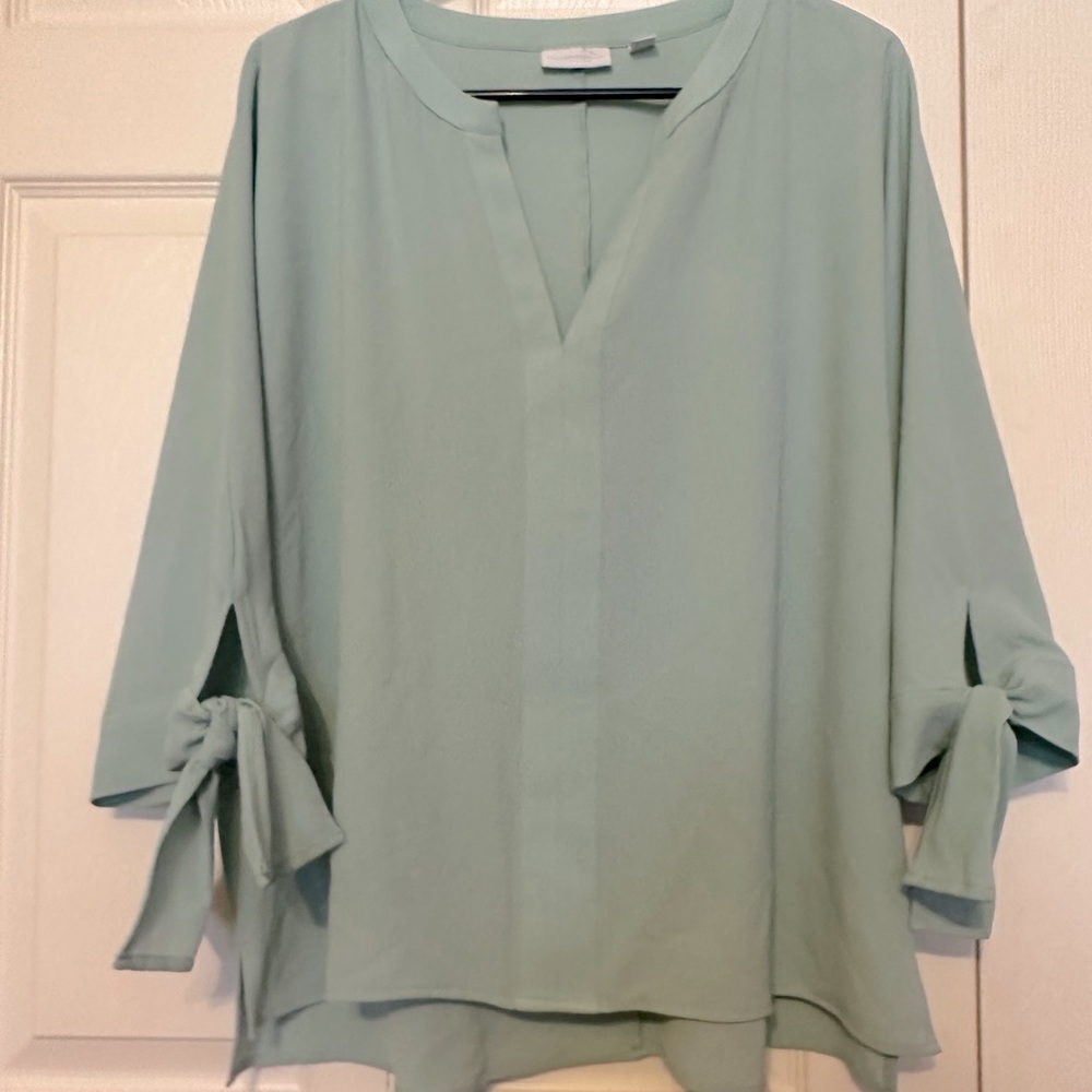 Light sea foam green colored blouse.